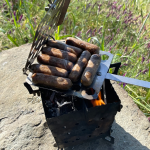 SIEGE Flat-Pack Stove grilling sausages